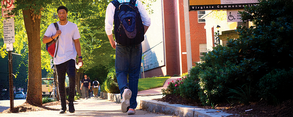 Morning scene along Franlin Street with student walking towards camera holding backpack.