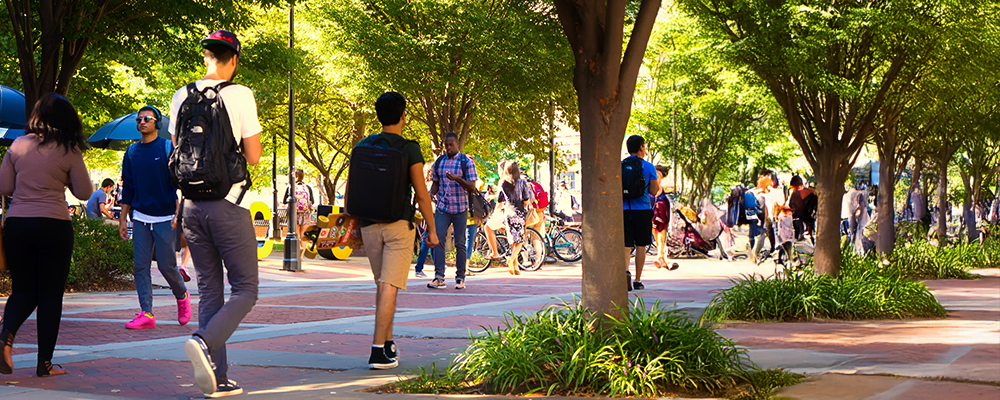 Students walking along Shafer Court at night.